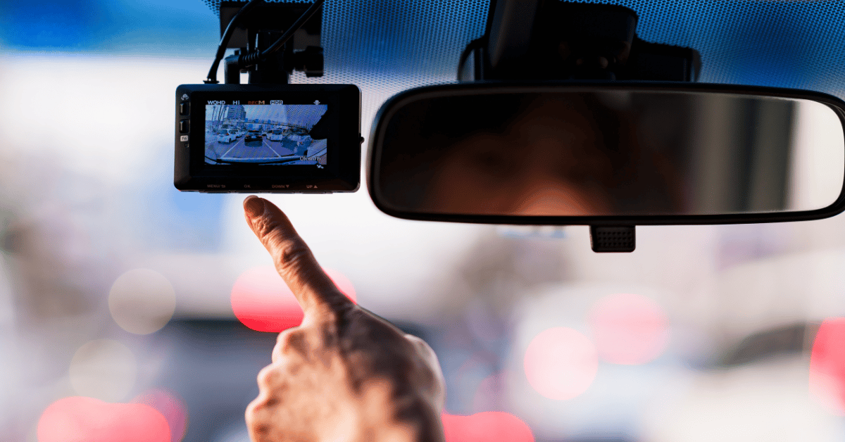 Finger pointing towards car dash cam