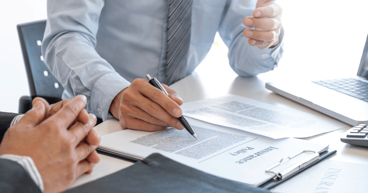 Insurance agent reviewing insurance policy with his client